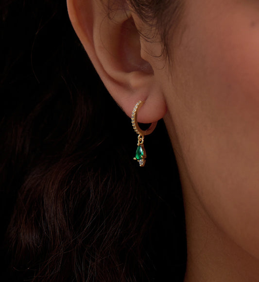 Close-up image of 925 sterling silver emerald teardrop huggies by Liora Senar