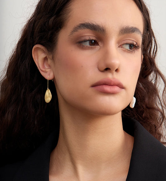 Model wearing hypoallergenic Baroque Pearl 925 Silver Asymmetric Drops by Liora Senar