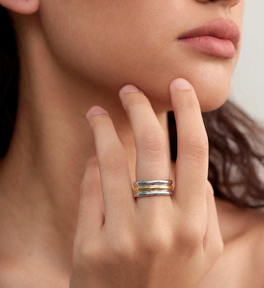 Close-up image of minimalist tarnish-free Bi-Stream Band Ring on a model by Liora Senar