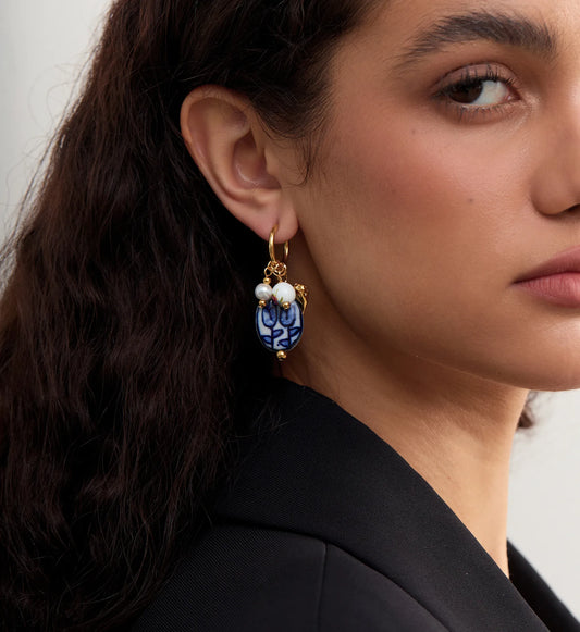 Side image of a model wearing hypoallergenic Ceramic Heart Charm Hoops by Liora Senar