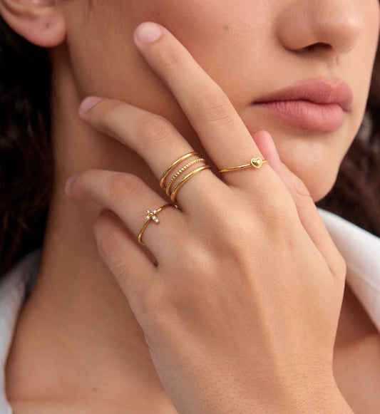 Model wearing tarnish-free Gold Cross-Heart Trio Ring Set by Liora Senar