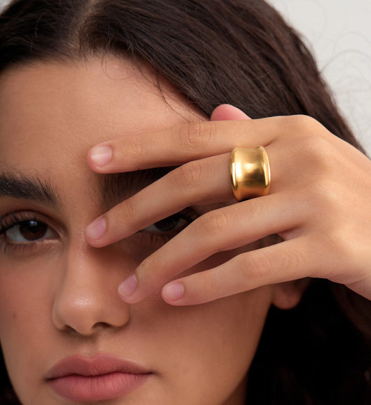 Close-up shot of model wearing gold stainless steel Dome Luxe Ring by Liora Senar