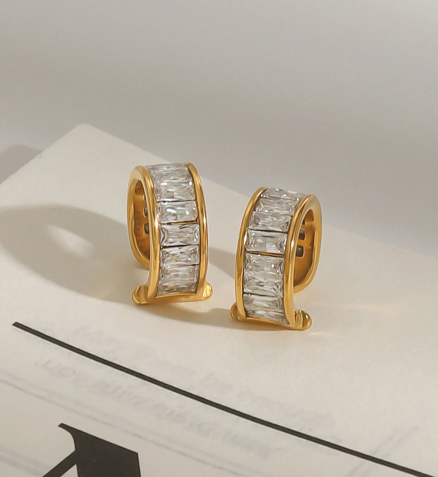 Minimalist stainless steel eos cuff earrings in lifestyle background by Liora Senar