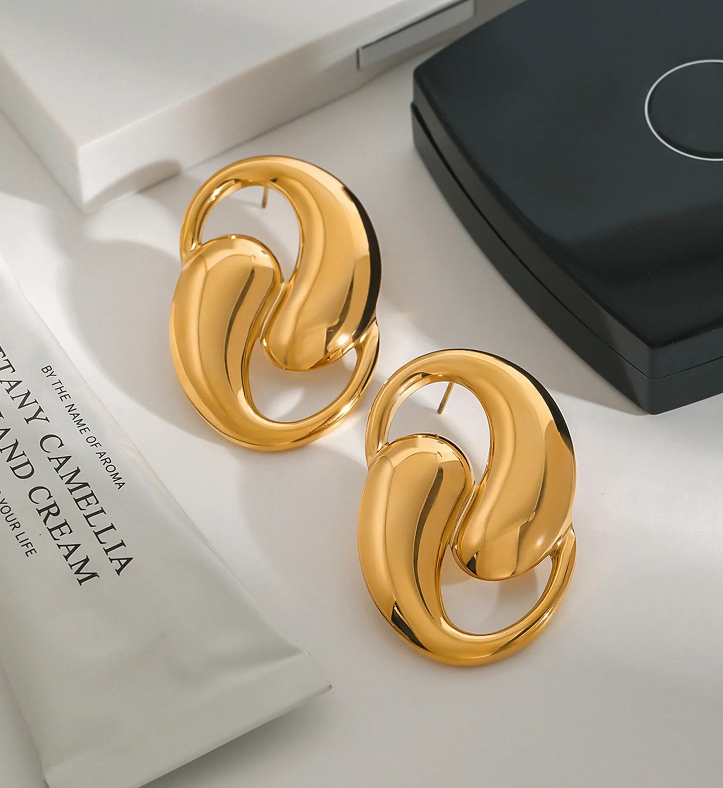 Stainless steel Glamour Spiral Earrings in a lifestyle background by Liora Senar