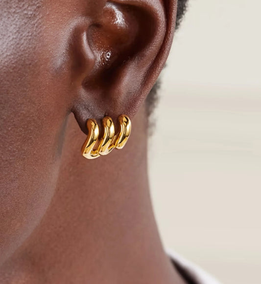 gold ripple curve earrings on a model minimalist waterproof stainless steel jewelry