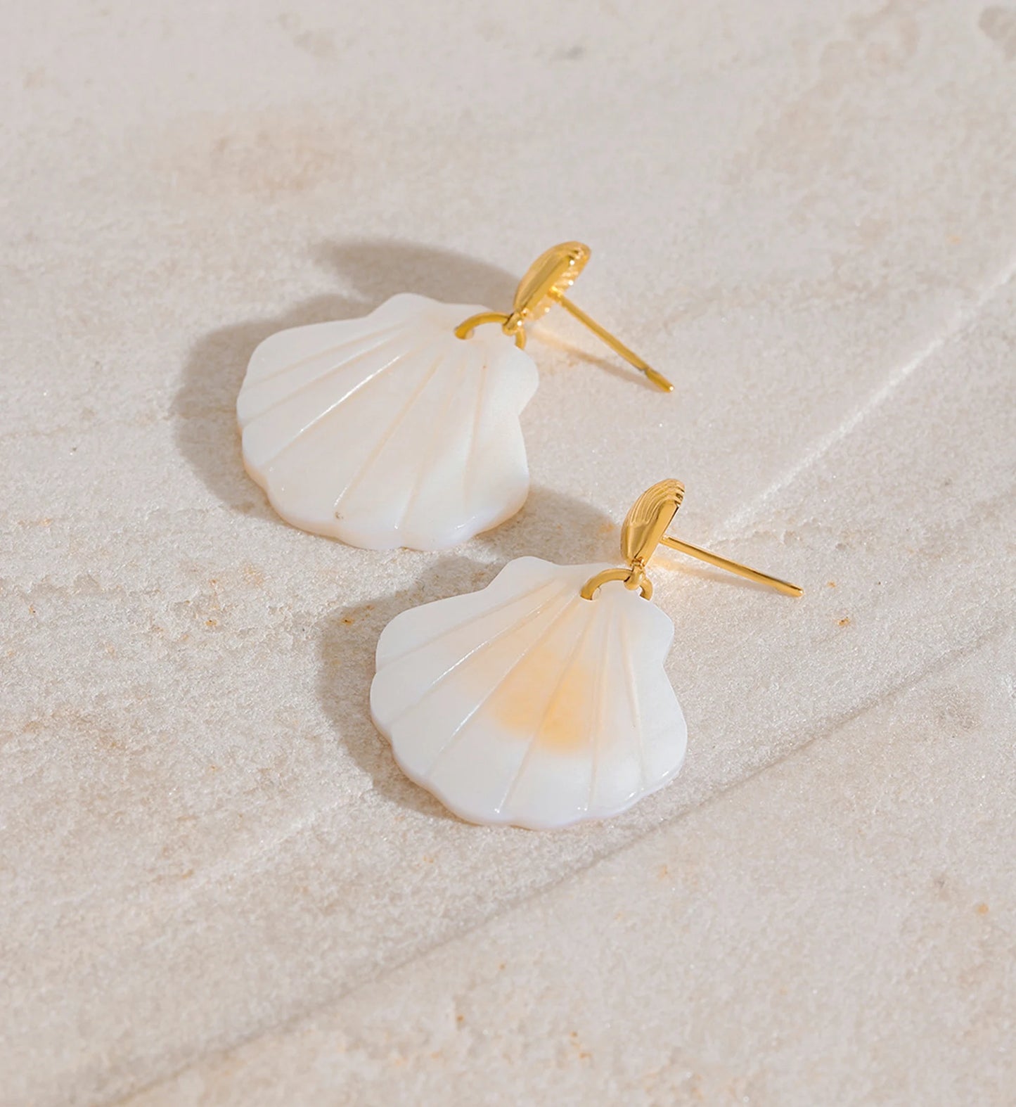 Waterproof Natural Shell Dangle Earrings on the marble by Liora Senar
