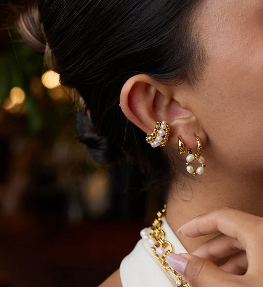 Model wearring hypoallergenic pearl huggie hoops bundle by Liora Senar