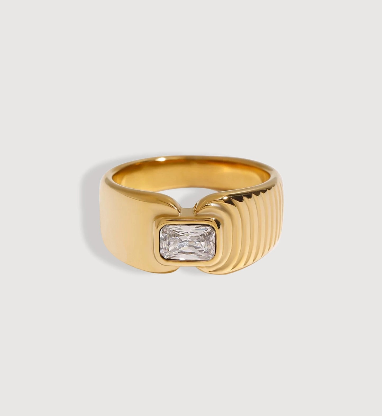 Gold color warranty Aurelia Ring in light gray background by Liora Senar