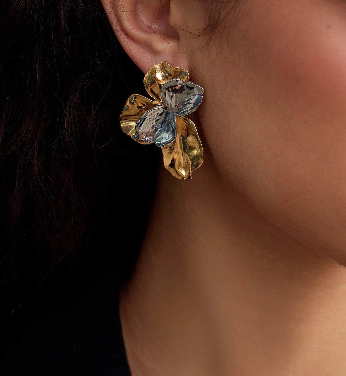 Close-up shot of model wearing Waterproof stainless steel Bi-Color Blossom Earrings by Liora Senar