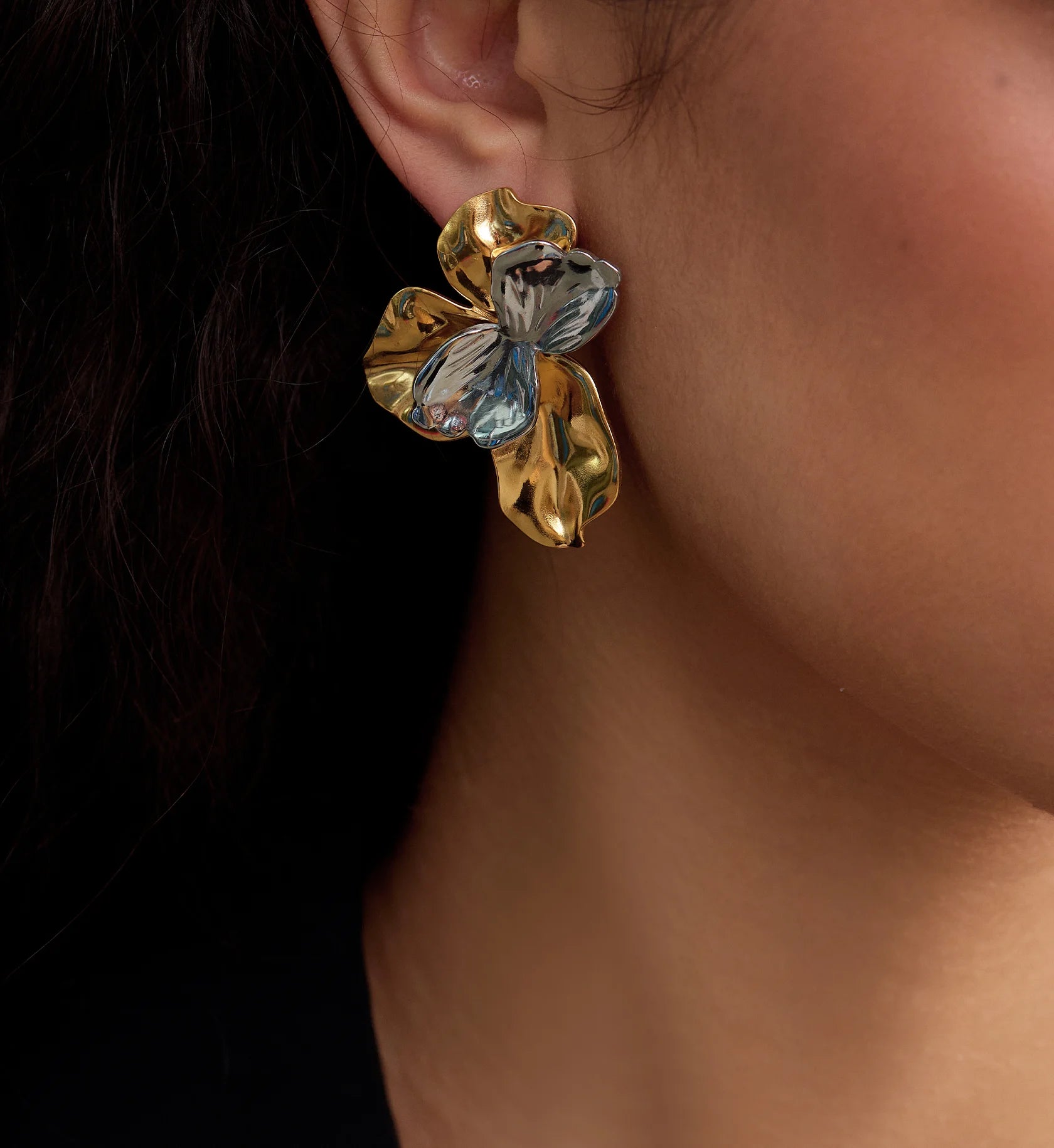 Close-up shot of model wearing Waterproof stainless steel Bi-Color Blossom Earrings by Liora Senar