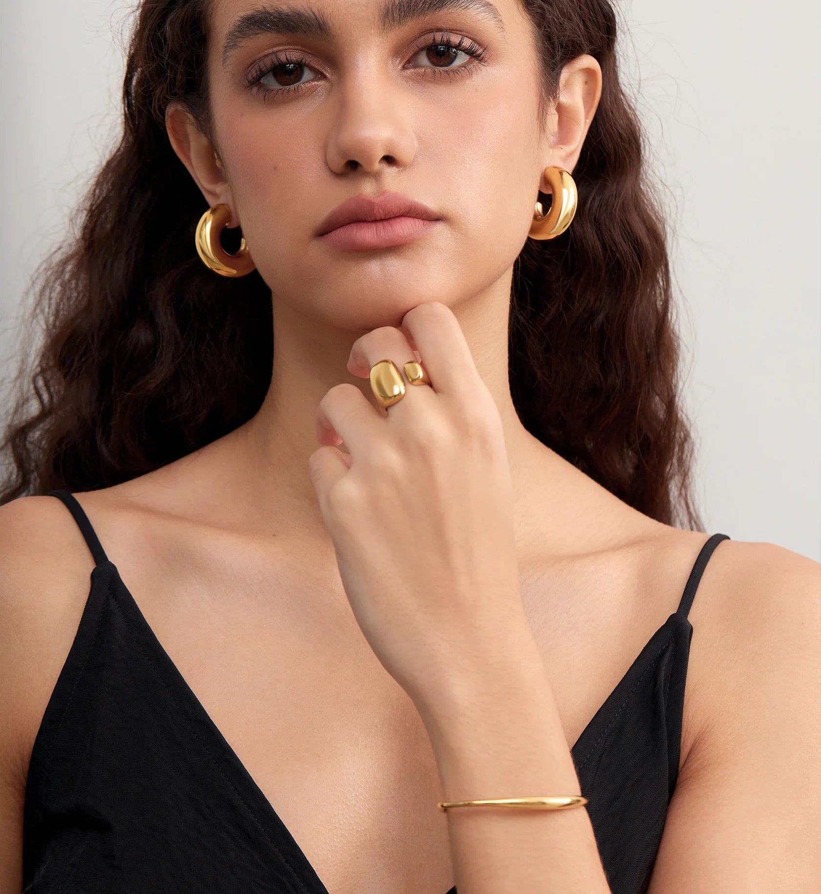 Model wearing waterproof stainless steel Bold Gold Chunky Hoops,Ring and Bracelet by Liora Senar