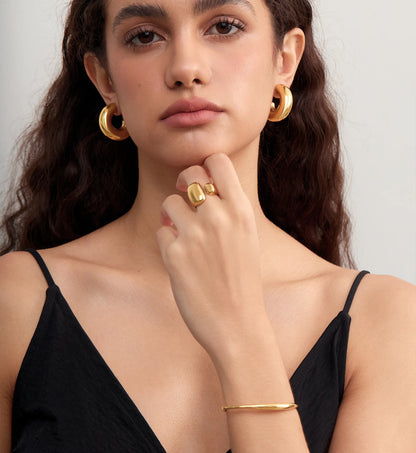 Model wearing waterproof stainless steel Bold Gold Chunky Hoops,Ring and Bracelet by Liora Senar