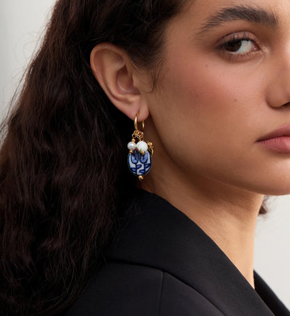 Side image of a model wearing hypoallergenic Ceramic Heart Charm Hoops by Liora Senar