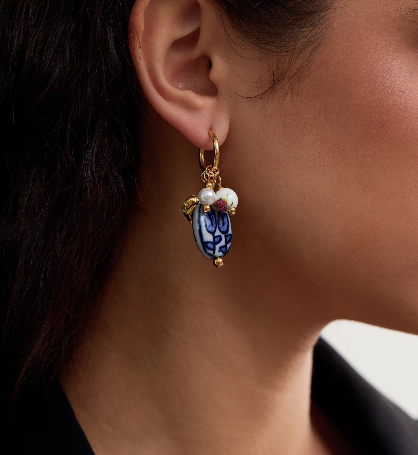 Close-up shot of color warranty Ceramic Heart Charm Hoops by Liora Senar