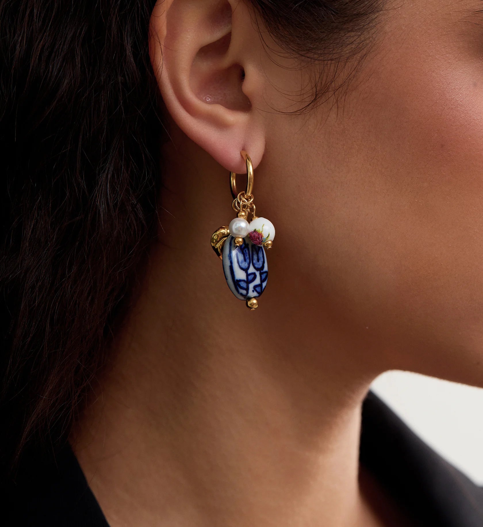Close-up shot of color warranty Ceramic Heart Charm Hoops by Liora Senar