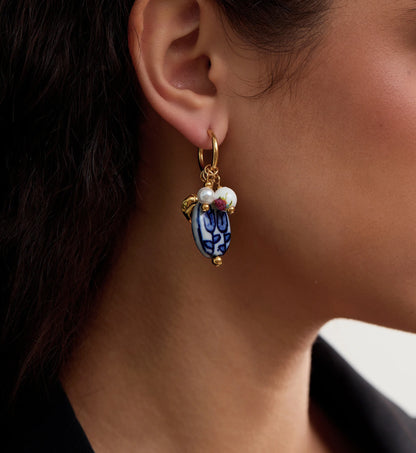 Close-up shot of color warranty Ceramic Heart Charm Hoops by Liora Senar