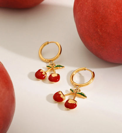 cherry kiss hoop earrings in a life style background minimalist waterproof stainless steel jewelry by Liora Senar