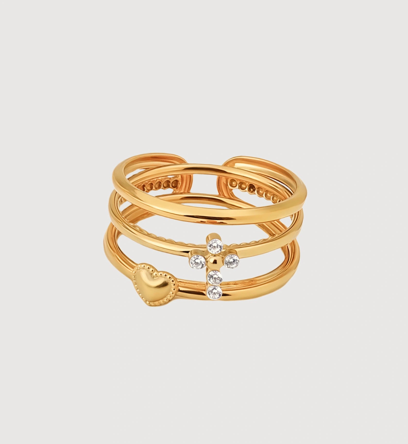Gold stainless steel Cross-Heart Trio Ring Set in light gray background by Liora Senar