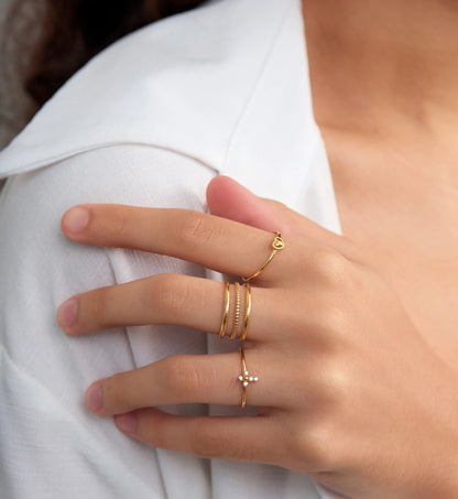 Gold stainless steel Cross-Heart Trio Ring Set on model's separate fingers by Liora Senar