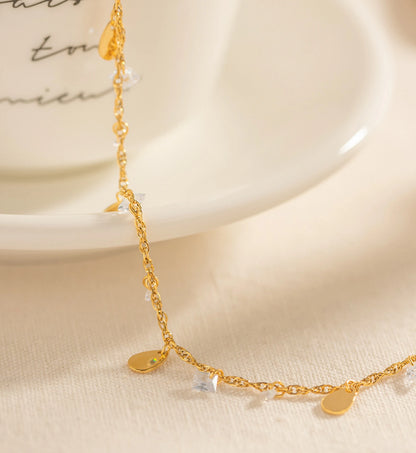 Close-up shot of detail of gold stainless steel Crystal Dew Anklet by Liora Senar