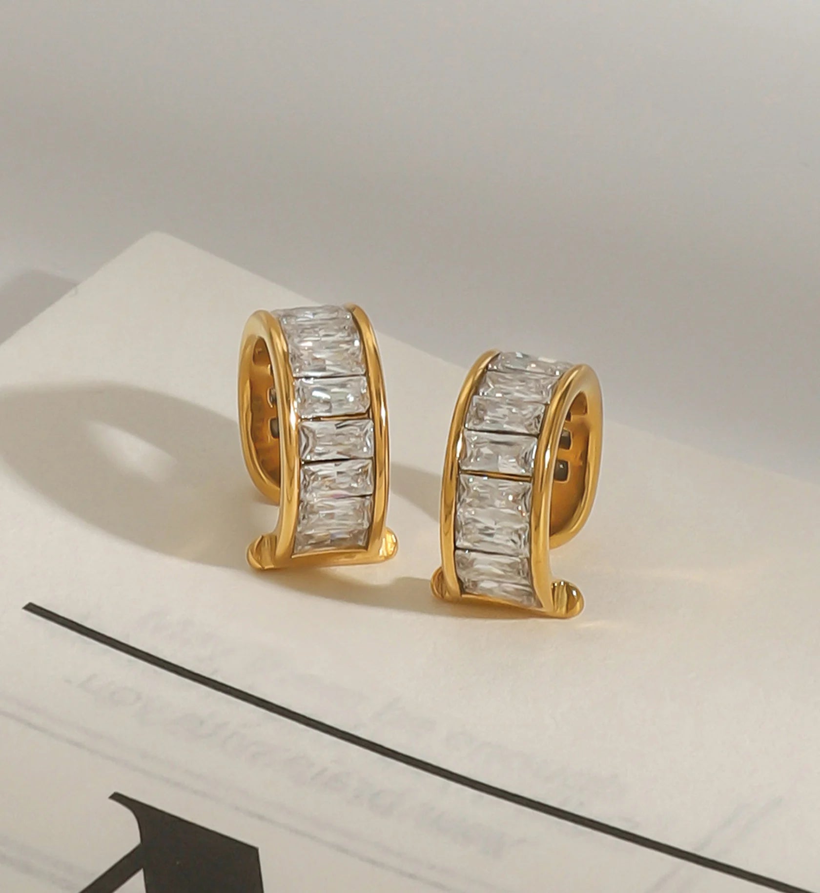 Minimalist stainless steel eos cuff earrings in lifestyle background by Liora Senar