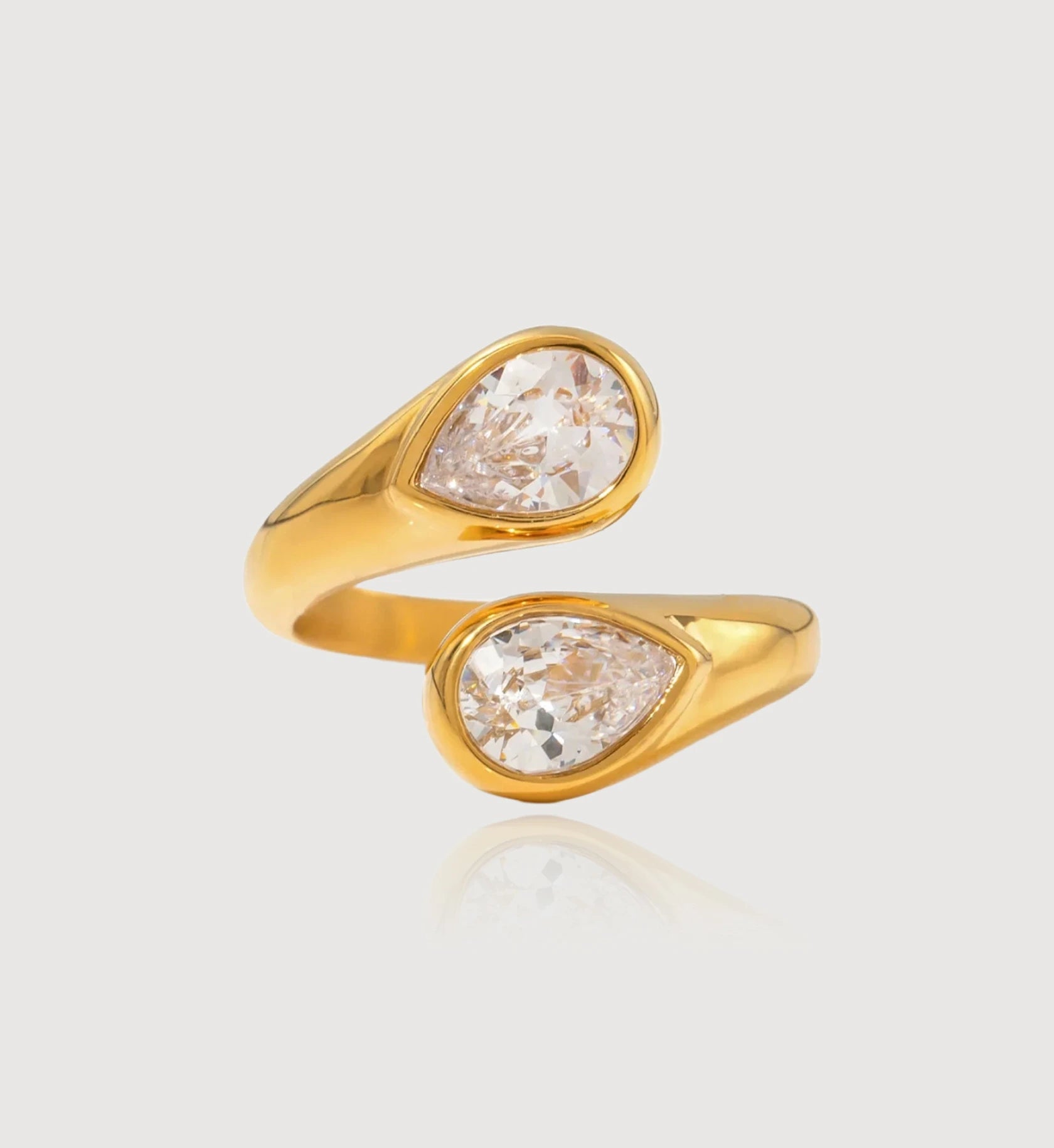 Gold waterproof Ethereal Drop Ring in light gray background by Liora Senar