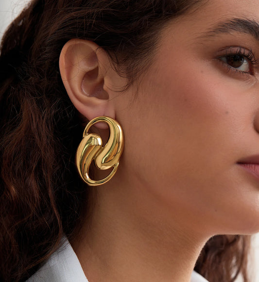 Hypoallergenic Spiral Earrings on a model's side face by Liora Senar