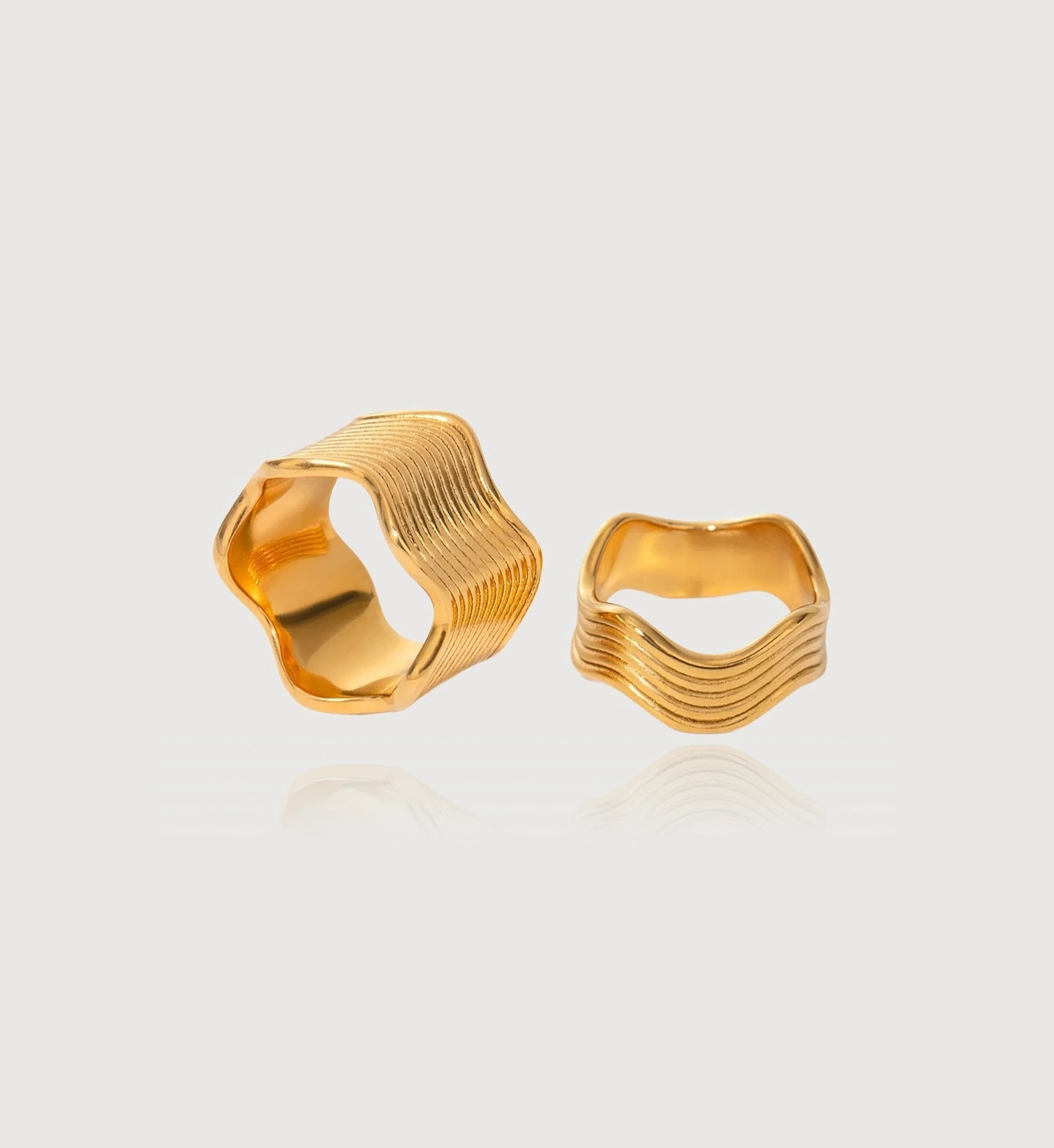 Waterproof stainless steel Gold Wave Ring in light gray background by Liora Senar