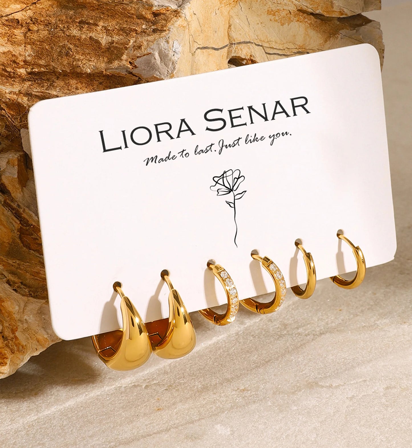 Minimalist mini trio hoops set hangging with a card by Liora Senar