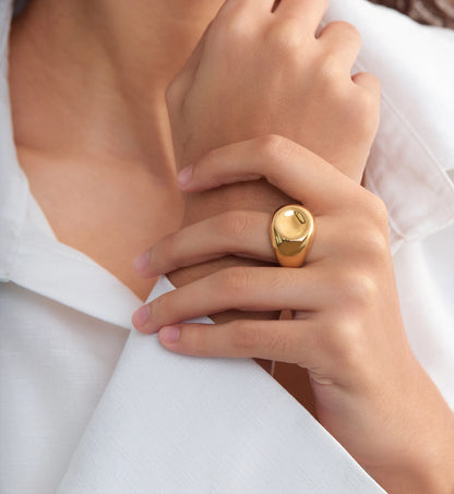 Close-up shot of Gold stainless steel Orb Lust Ring on model‘s hand by Liora Senar