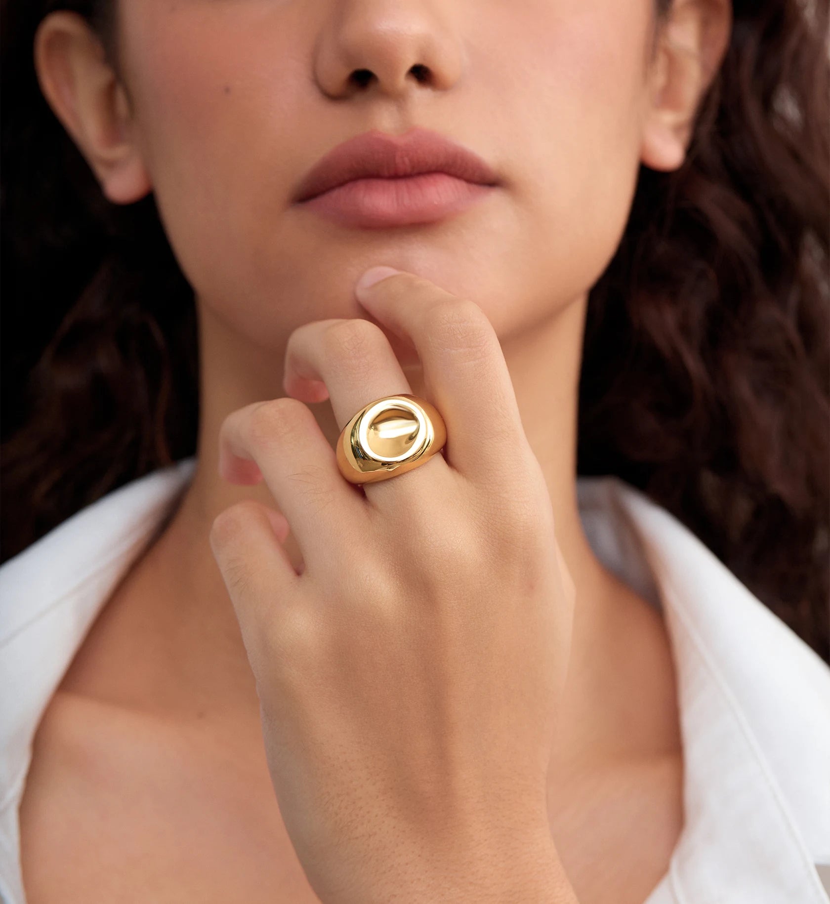 Model wearing gold color warranty Orb Lust Ring by Liora Senar