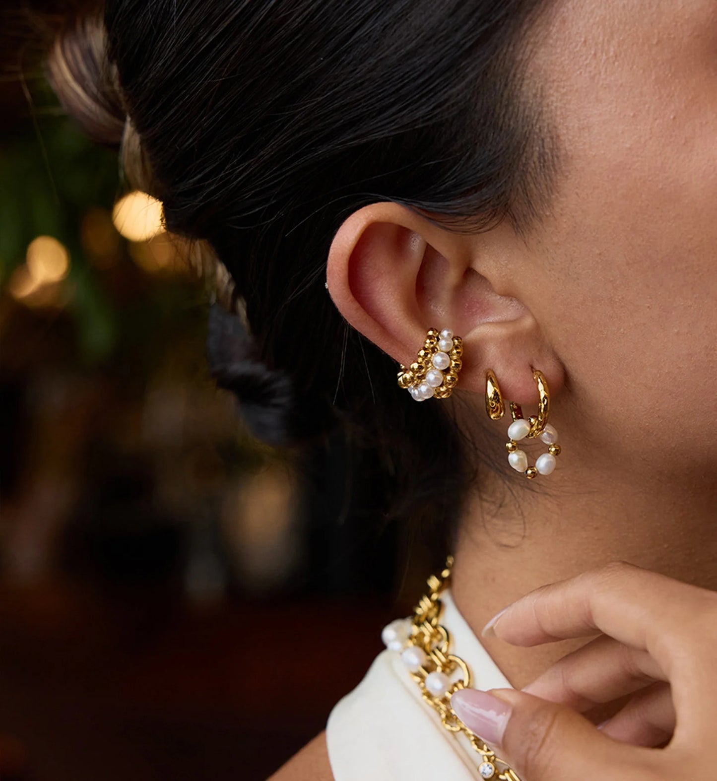 Model wearring hypoallergenic pearl huggie hoops bundle by Liora Senar