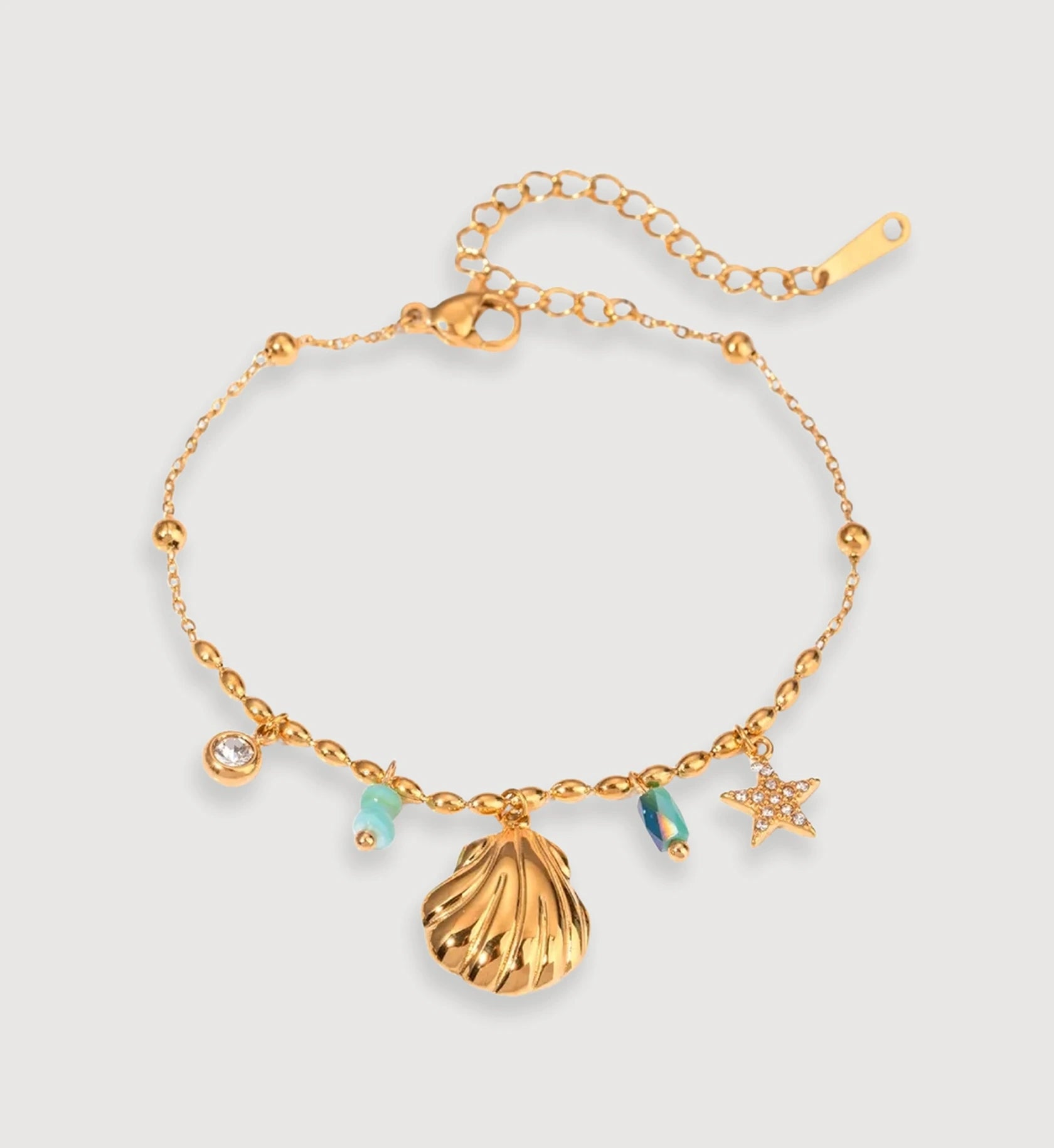 Gold stainless steel Seashell Star Bracelet in light gray background by Liora Senar