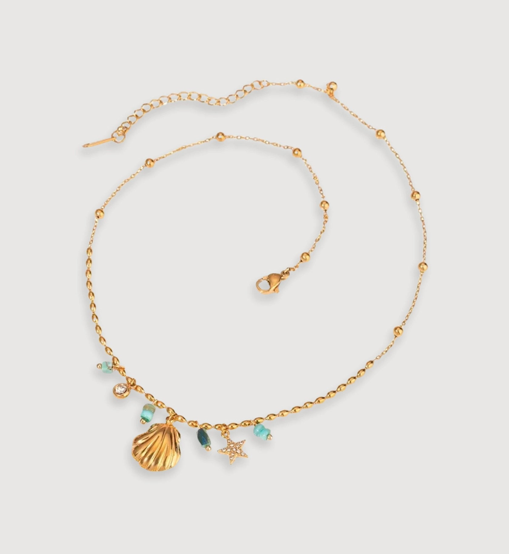 Gold stainless steel Seashell Star Necklace in light gray background by Liora Senar
