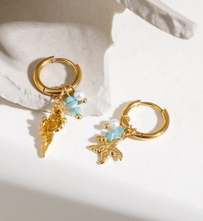 Waterproof stainless steel shell & starfish charms huggie earrings on a stone by Liora Senar