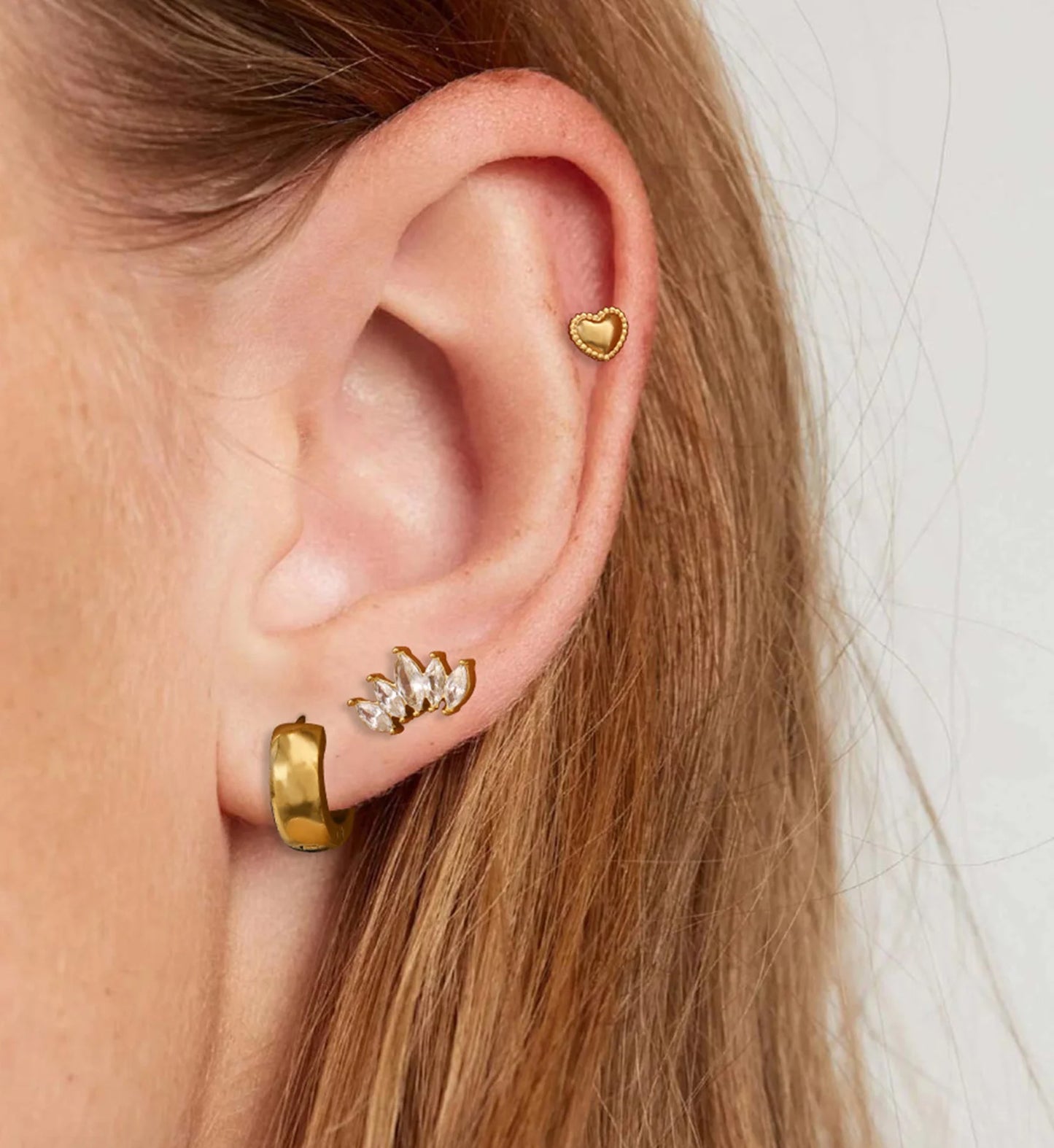 Hypoallergenic versatile heart earrings set on a model by liora senar